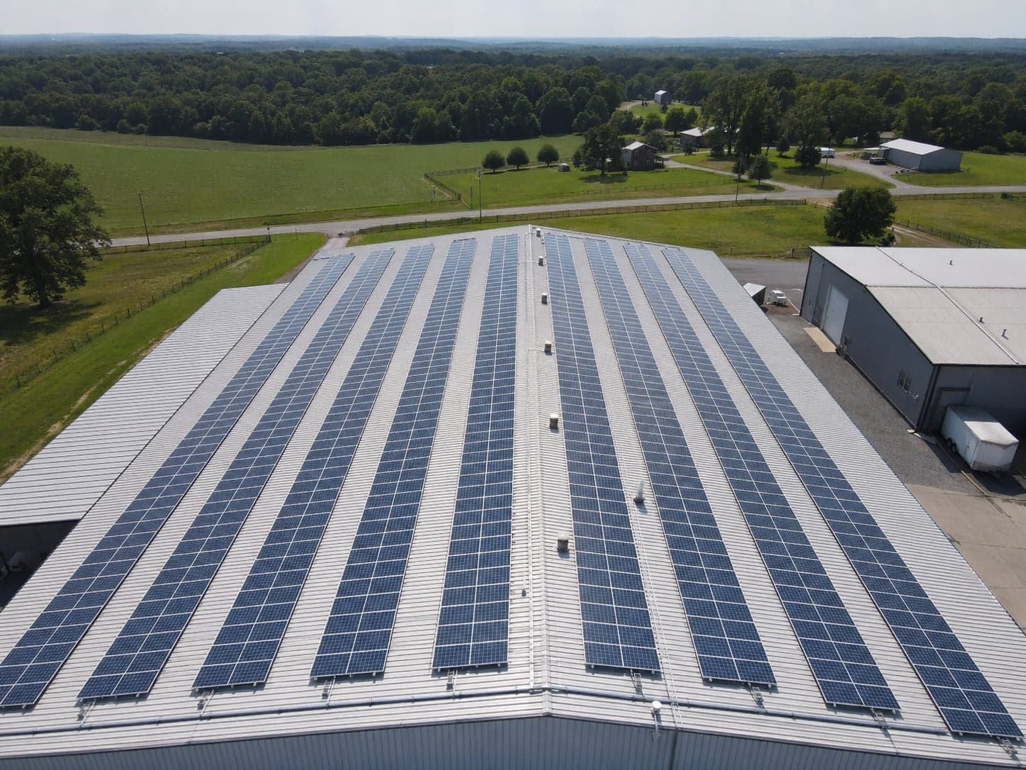 Aerial drone view of a commercial rooftop solar panel array